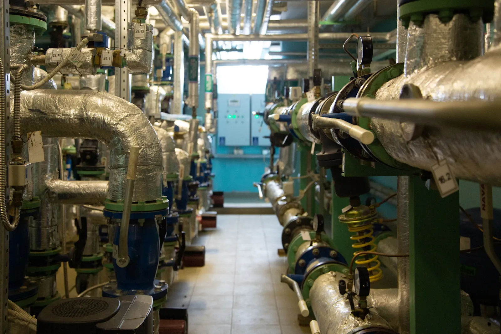 Insulated building services pipes, valves and gauges in a plant room