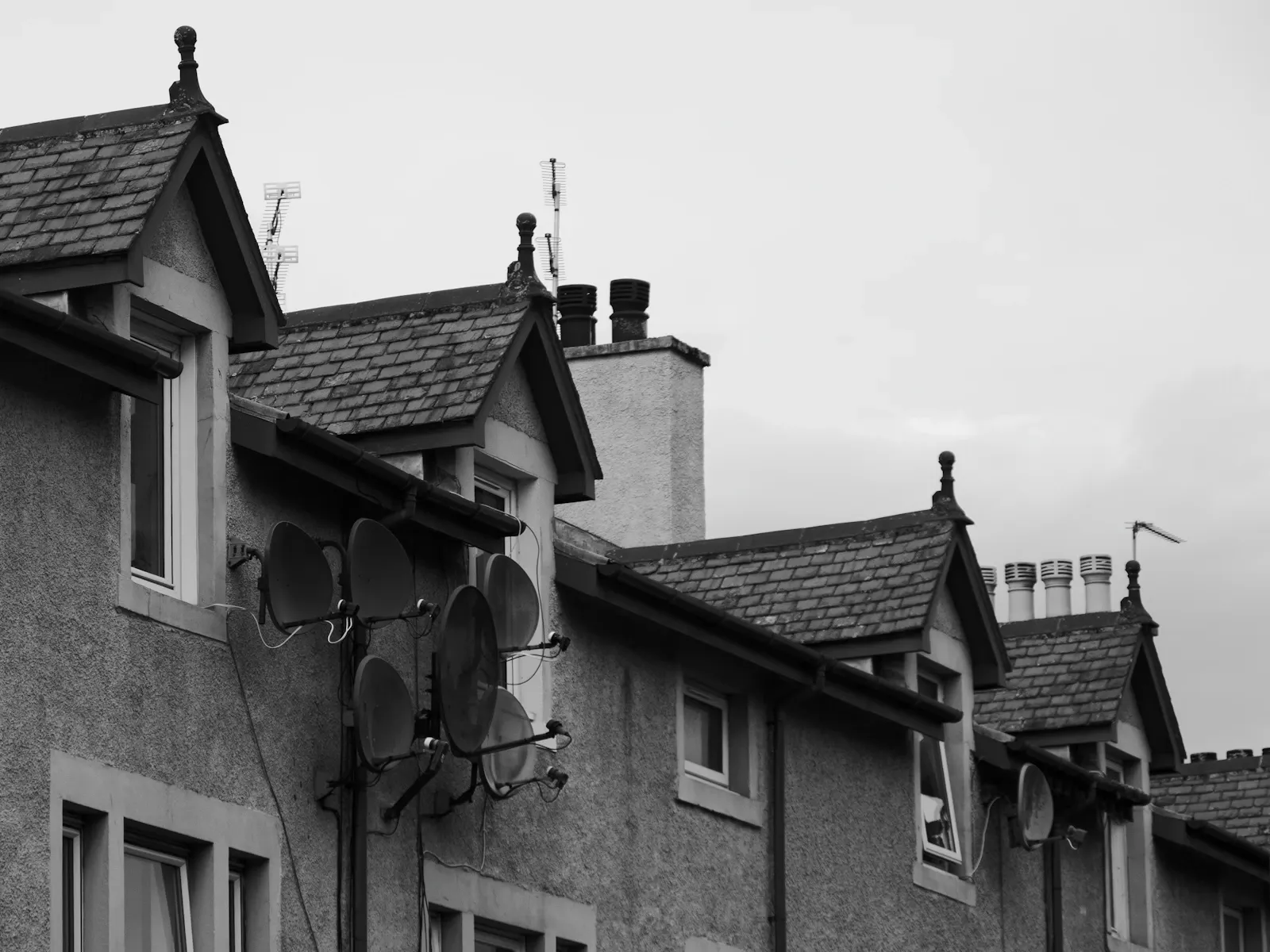 Black and white photograph of residential buildings with gabled roofs in Inverness, Scotland