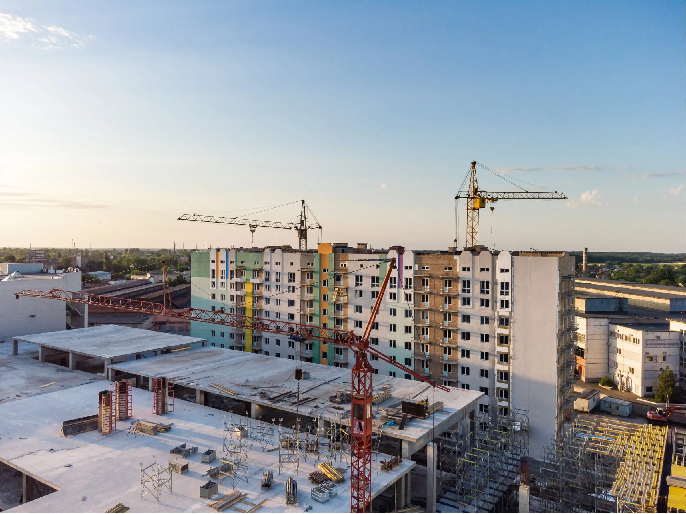 Building under construction with cranes and active site works