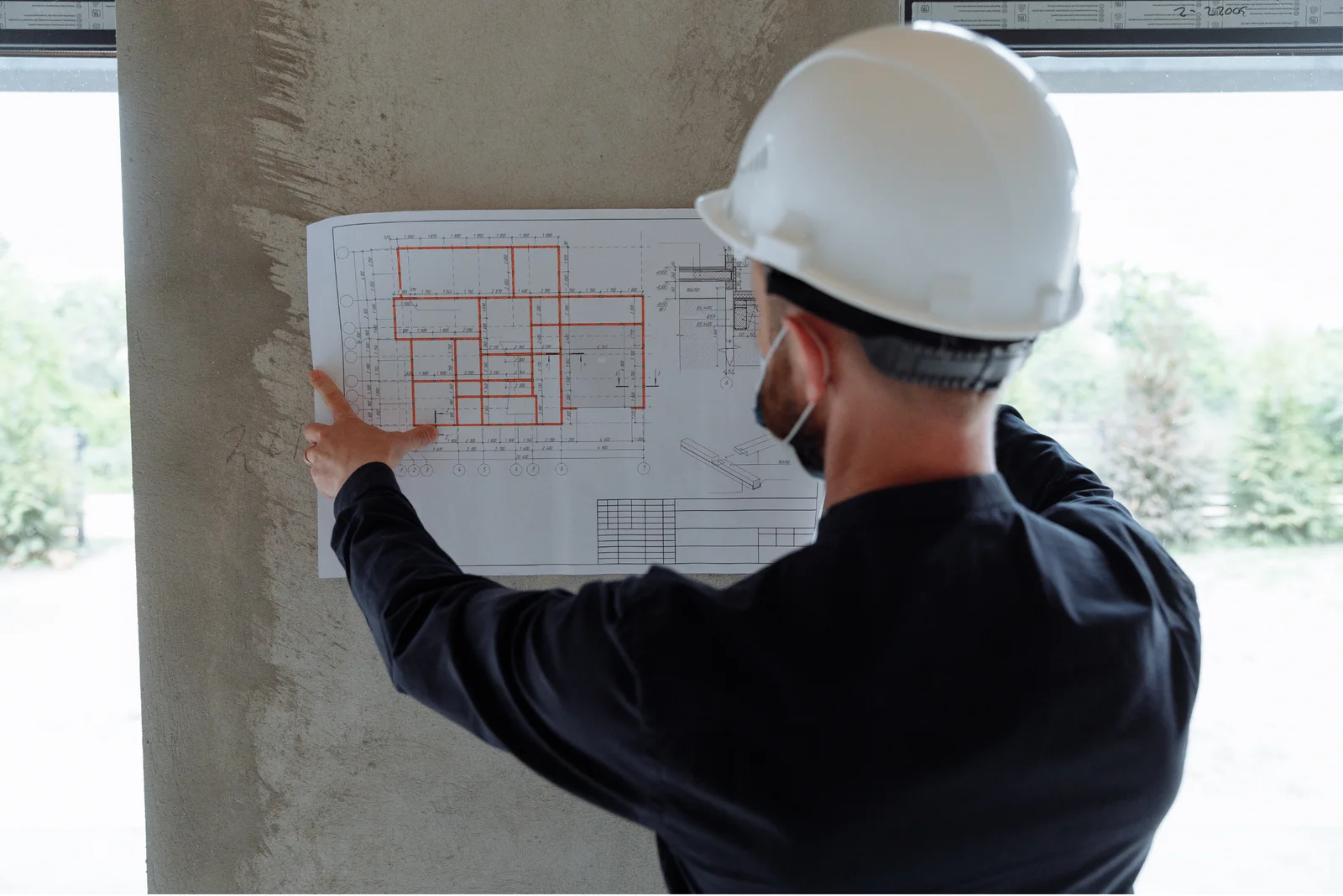 Construction professional reviewing an architectural plan on site